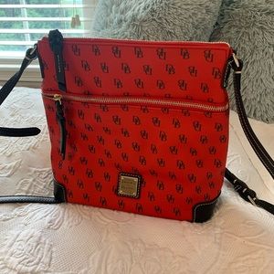 Reddish orange or orangish red Dooney and Bourke bag.